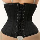 Black corset worn by a person on a plain background