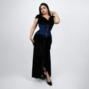 Woman wearing a black evening gown with blue sequin details on a white background