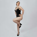 Model wearing black PVC underbust corset from side angle showing hourglass silhouette and hook and eye closure -- Daphne by Corsets Island
