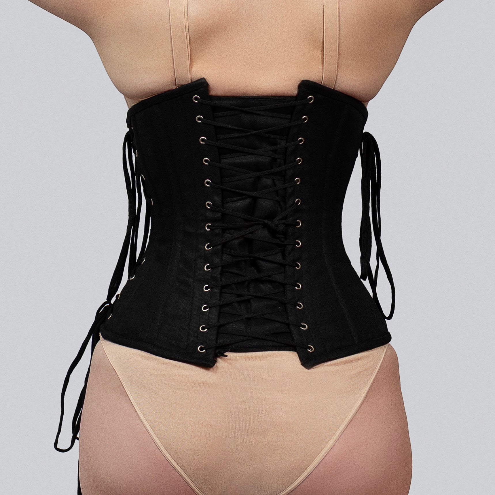 Back view of black cotton underbust corset showing lace-up closure and modesty panel -- Daphne by Corsets Island