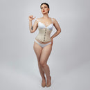Woman wearing a beige waist trainer with white underwear on a gray background